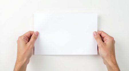 Male hands holding white paper mockup on white background Male hands holding white paper mockup on white background