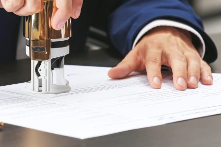 Notary public in office stamping document Notary public in office stamping document