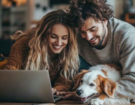 A couple relaxing on the floor while their dog looks at a laptop, great for social media posts or family moments A couple relaxing on the floor while their dog looks at a laptop, great for social media posts or family moments.